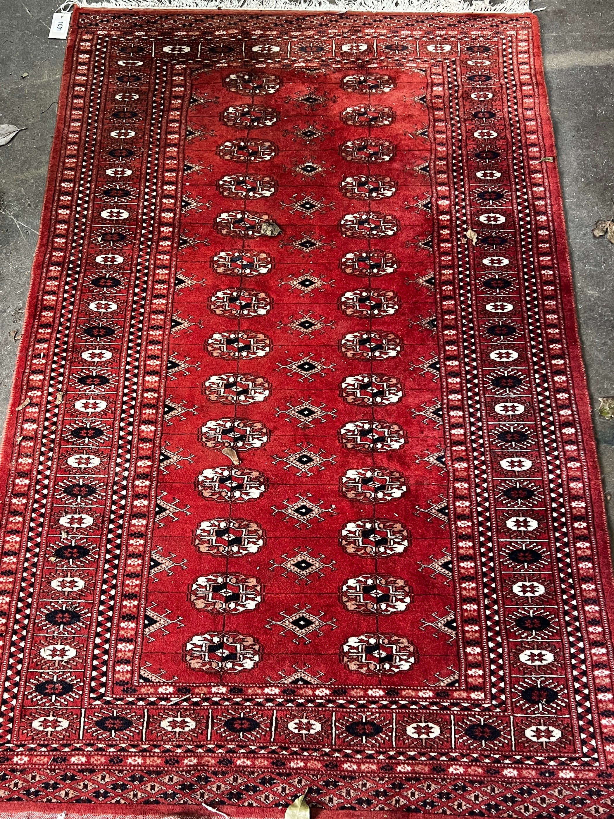 A Bokhara red ground rug, 150 x 95cm